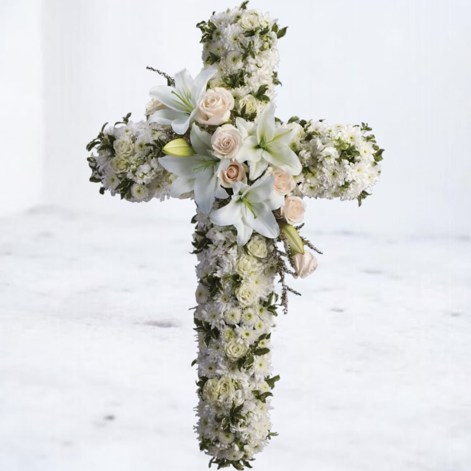 Divine Grace Cross – Funeral Standing Cross with Pink & White Flowers Divine Grace Cross – Funeral Standing Cross with Pink & White Flowers - Honor a cherished life with the Divine Grace Cross, a stunning floral tribute that symbolizes peace, faith, and eternal love. This elegant funeral cross features pure white roses, serene lilies, and delicate white blooms, thoughtfully accented with soft greenery for a graceful and timeless display. Perfect for memorial services, funerals, or celebrations of life, this arrangement offers a heartfelt expression of sympathy and reverence. The Divine Grace Cross beautifully honors a life filled with grace, devotion, and everlasting remembrance. All floral crosses come with easels included for seamless presentation at memorials or services.