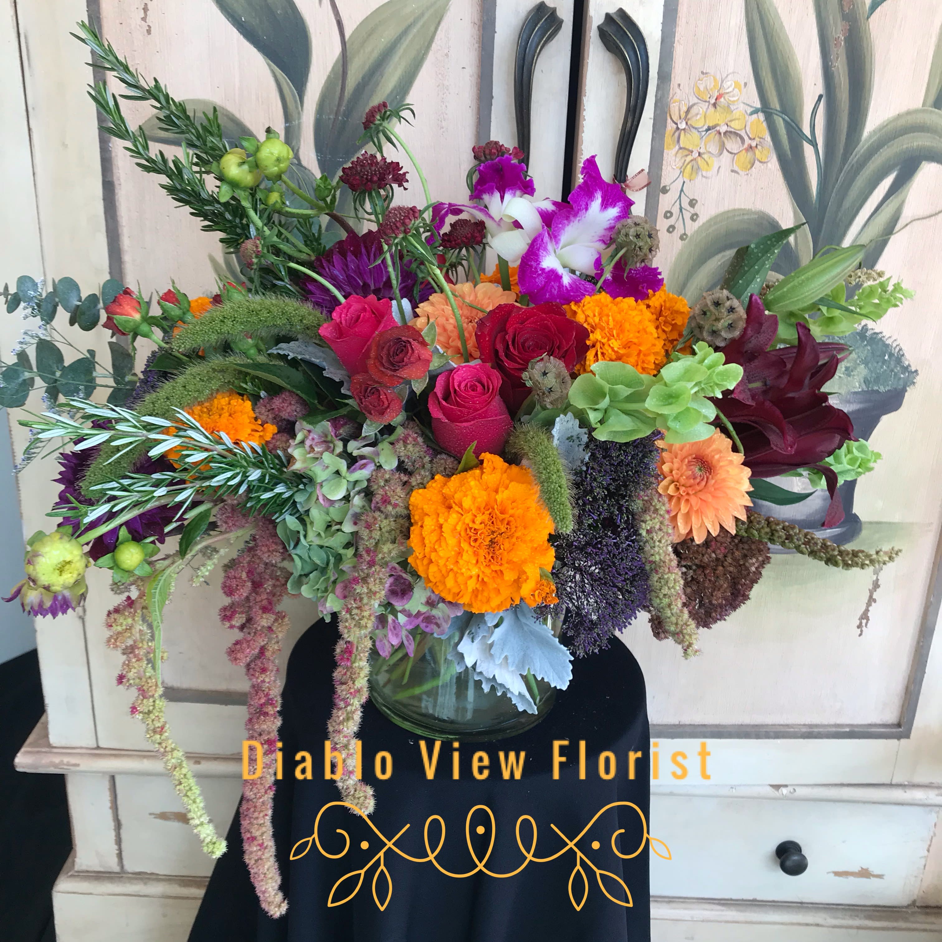 The Elle The Elle - Assorted flowers to include Dahlia, Marigolds, Rosemary and Roses.