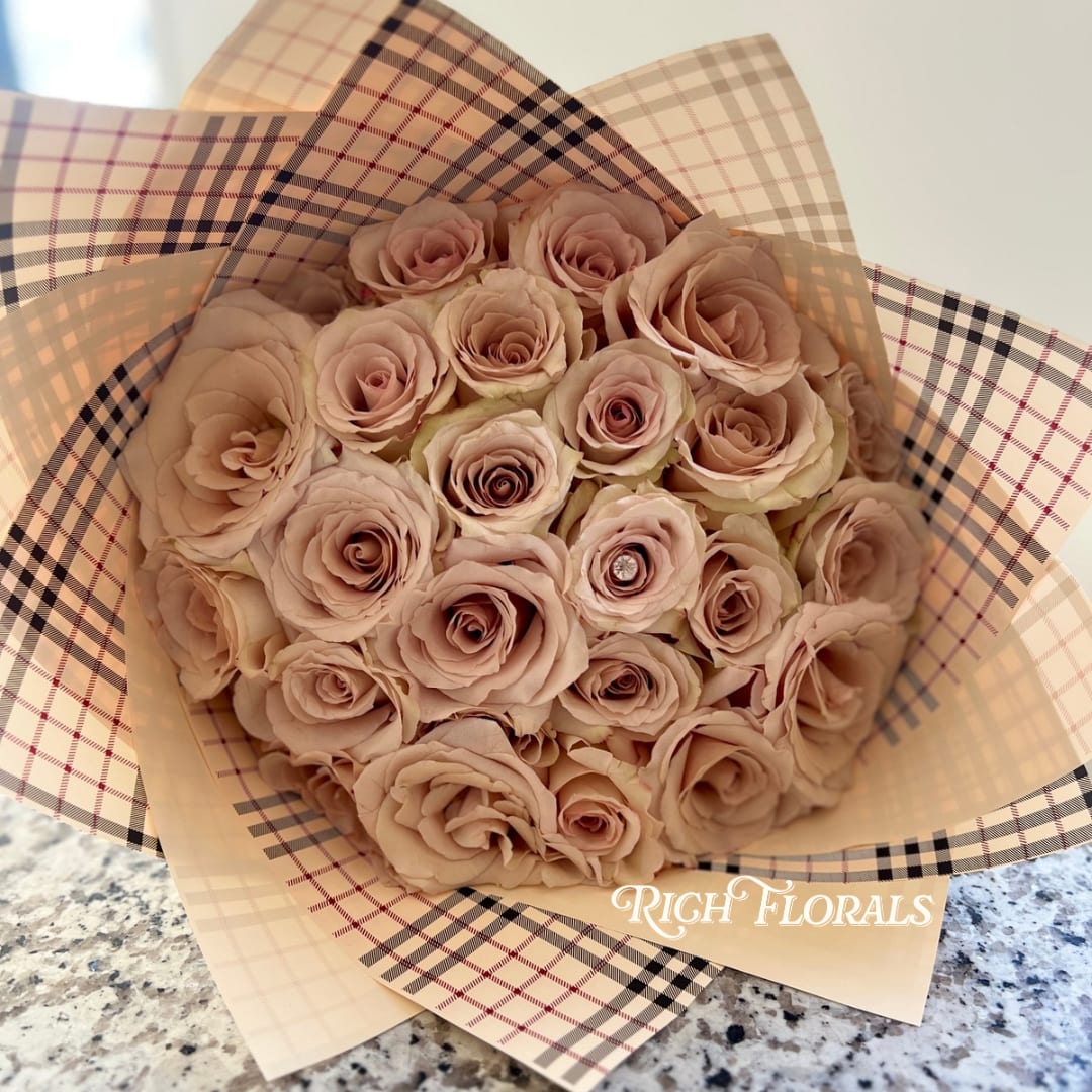 Burberry Bouquet - Featuring 18 luxurious creamy roses this bouquet is wrapped in distinctive Burberry-inspired plaid print paper and secured with a chic white ribbon. 