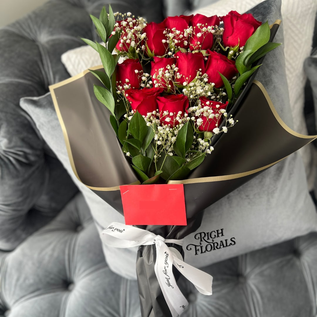 Dozen Roses Bouquet - Say hello to our Dozen Roses Bouquet, your go-to for a sweet surprise. Wrapped in a cool, flat style and tied up with a ribbon, each bouquet comes with a little packet of flower food and a card where we’ll add your personal message for that special touch. It's the perfect way to spread some love, celebrate, or just make someone’s day a bit brighter. Please add rose color at checkout.