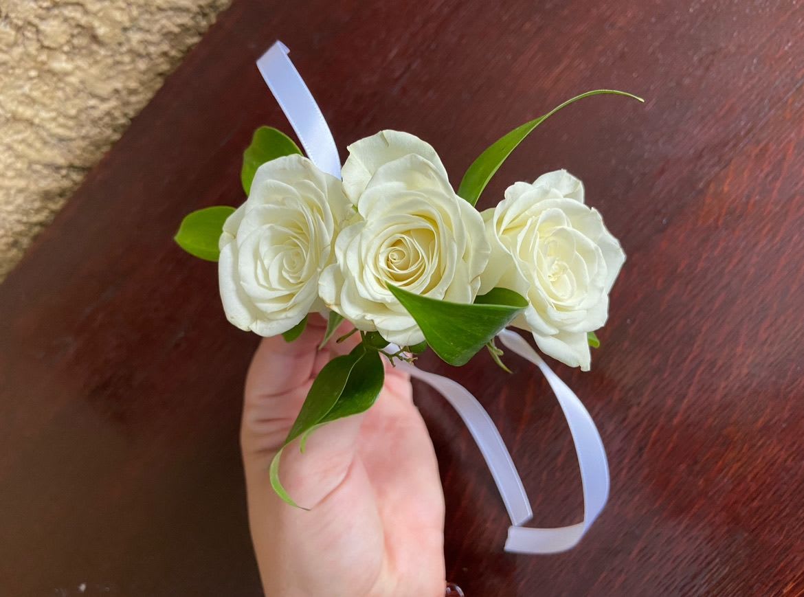 Cha Cha - A cha cha is a bracelet made up of small roses connected by wire and tied by ribbon. Please specify if cha cha is intended for an adult or child. Please also add color of roses and ribbon that is desired in notes to florist.
