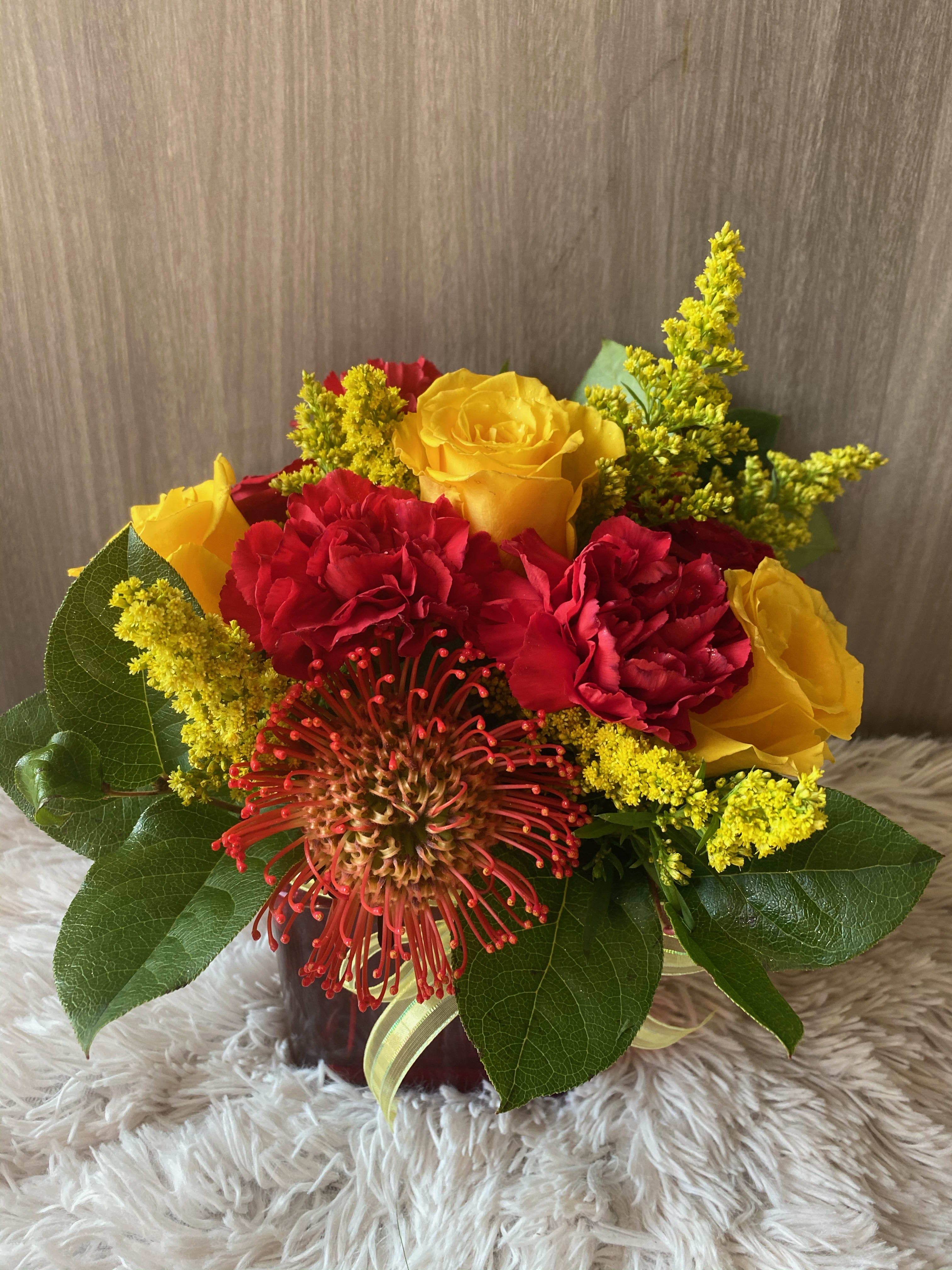 Sunset Splash Sunset Splash - We will add the pin cushion flower if available. A mix of Roses and Carnations.