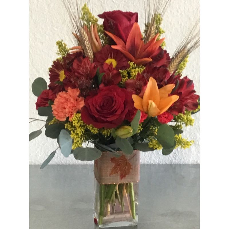 Autumn Red - Assorted fresh cut blooms beautifully designed in Autumn reds Product ID: DCFAR LARGER THAN PICTURE  