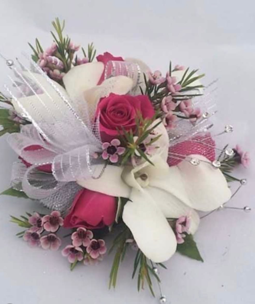 Hot pink and white corsage - This corsage features hot pink spray roses and white dendrobium Orchids. This corsage is simply elegant.