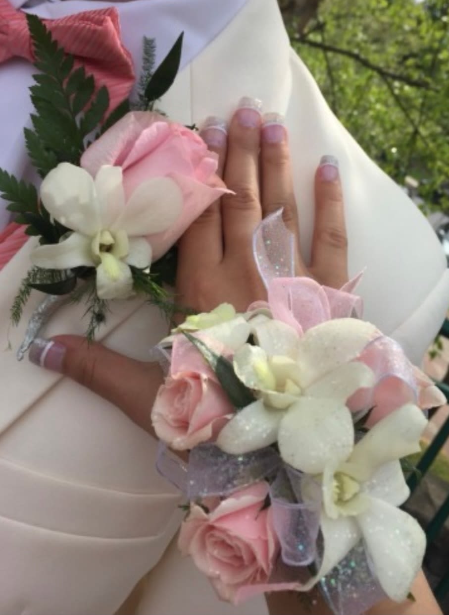 Combo corsage and boutineer - This corsage and boutineer combo feature pastel pink spray roses and white dendrobium orchids. 