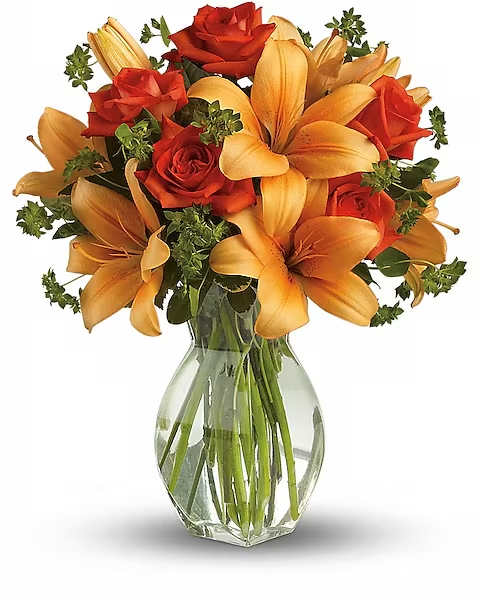 Fiery Lily and Rose - Spark someone's attention by sending this absolutely radiant bouquet. Full of flowers and fiery beauty, it makes a beautiful gift for any occasion. Features dark orange roses and orange asiatic lilies in a charming glass vase. It's fiery and it's fabulous!   Orientation : All-Around  All prices in USD ($)  Due to an increase in the cost of flowers and supplies we have had to raise our pricing.