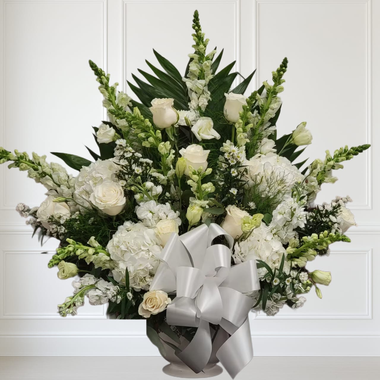 Sweet Comfort by Manny ™ Sweet Comfort by Manny ™ - An all white tribute, this funeral basket is pure and tranquil. Featuring a variety of white flowers and greenery, this design reaches for the sky and evokes a feeling of peace upward and outward.