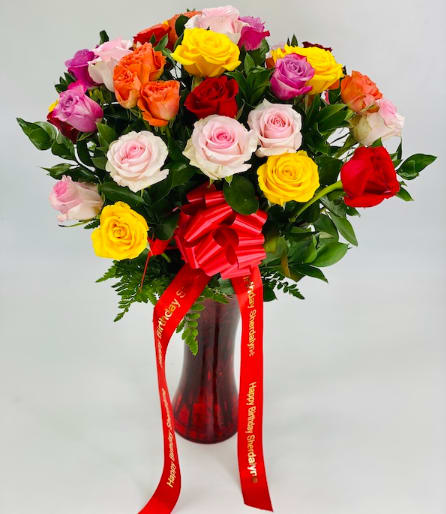 Dozen Assorted Roses - Full of life this arrangement will fulfill the heart of your loved ones!!!  Standard: One Dozen Deluxe: Two Dozen Premium: Three Dozen  Includes:  Assorted color Roses, Bow, Vase  The Personalized ribbon with the message has an extra cost.  