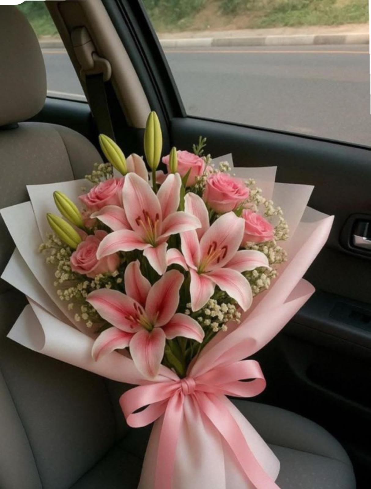 Sweetheart Wrapped - A graceful bouquet of pink lilies and blush roses, wrapped in beautiful waterproof paper. This bouquet speaks about love- tender, elegant, and unforgettable. Perfect for anniversaries, proposals, or just because. 