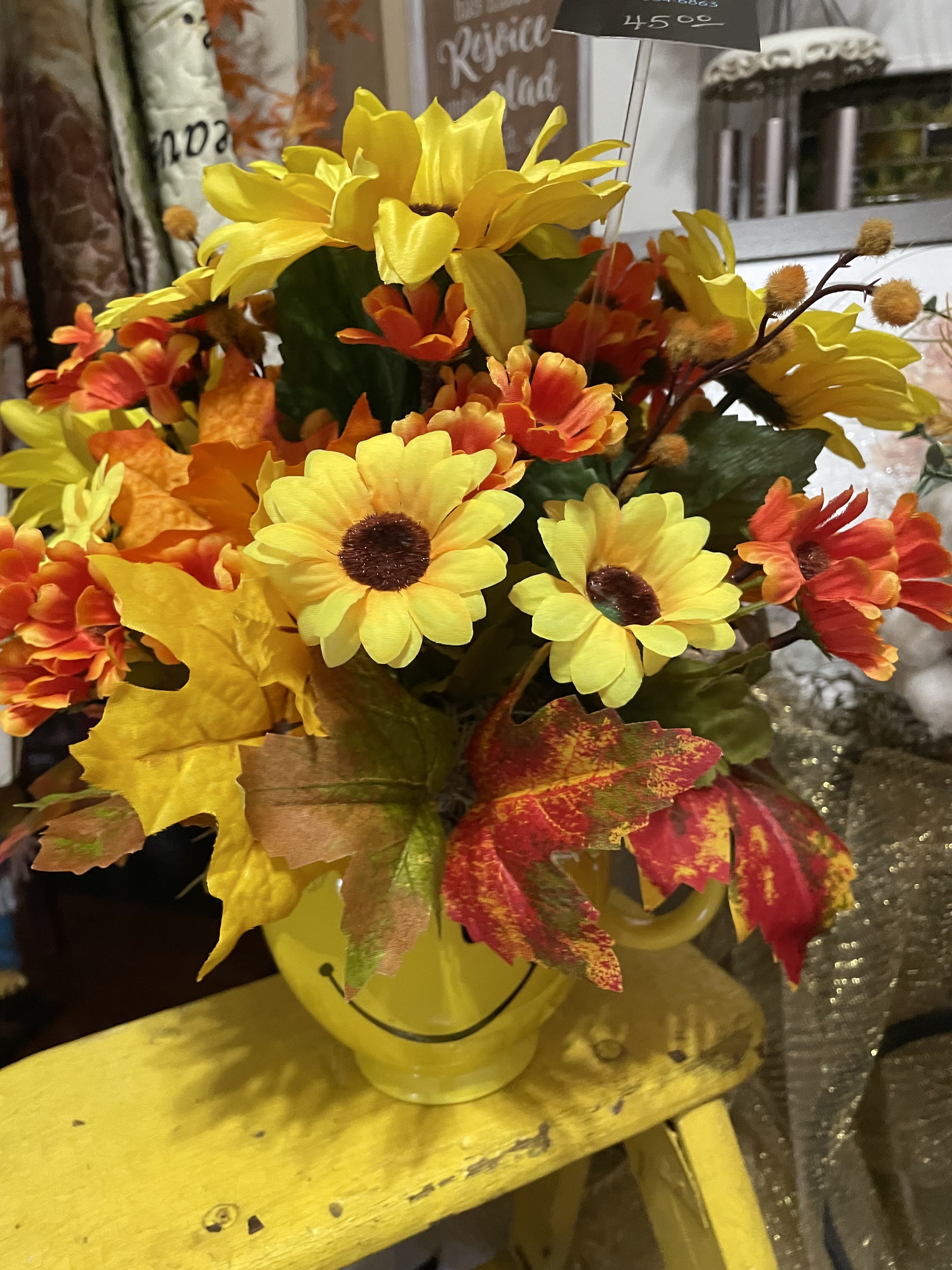 Autumn Be Happy Silk Bouquet  - Small, Simple, and happy —fits most any decor, with just the right amount of color in a happy face container. Silk Flowers.
