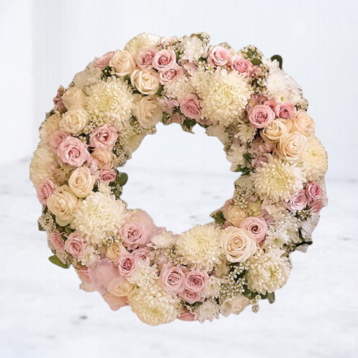 Peaceful Infinity Wreath Peaceful Infinity Wreath - The Peaceful Infinity Wreath is a timeless expression of love and remembrance, offering comfort and serenity in times of loss. This elegant funeral wreath features soft pink and ivory roses, white chrysanthemums, and delicate baby’s breath, carefully arranged to create a heartfelt tribute. Its circular design symbolizes eternal love and the unbroken circle of life. Perfect for honoring a loved one at funerals or memorial services, the Peaceful Infinity Wreath is available for same-day delivery in Houston and surrounding areas. Let this beautiful arrangement serve as a touching expression of sympathy and support for grieving families. Easels are included in the price of all wreath arrangements to ensure easy display at services.