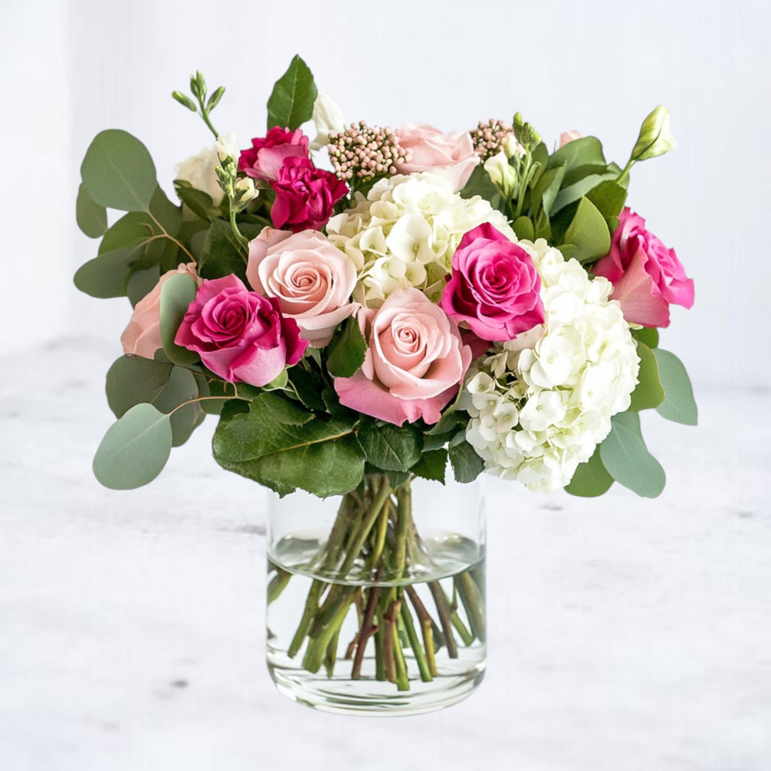 Sweet Affection Sweet Affection - Sweet Affection is a graceful medley of soft pink roses, vibrant fuchsia blooms, and fluffy white hydrangeas, designed to express love, admiration, and heartfelt joy. Hand-arranged in a clear glass vase, this romantic bouquet blends lush textures with timeless charm, making it the perfect gift for anniversaries, birthdays, or spontaneous “thinking of you” moments. Whether you’re celebrating a milestone or sending a sweet surprise, Sweet Affection delivers beauty and emotion in every petal — available for same-day delivery across Houston and surrounding areas.