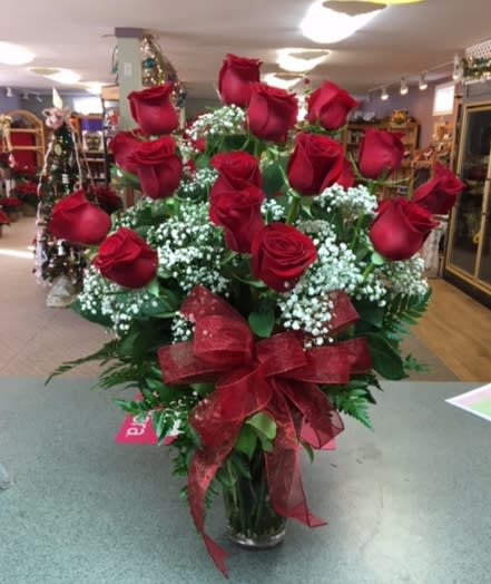 24 Long Stem Red Roses (R24) 24 Long Stem Red Roses (R24) - Two dozen long stem red roses with assorted greens, gypsophila, designed in a clear glass vase adorned with a matching bow. ** If there is another color you would like, please note that in the special instructions