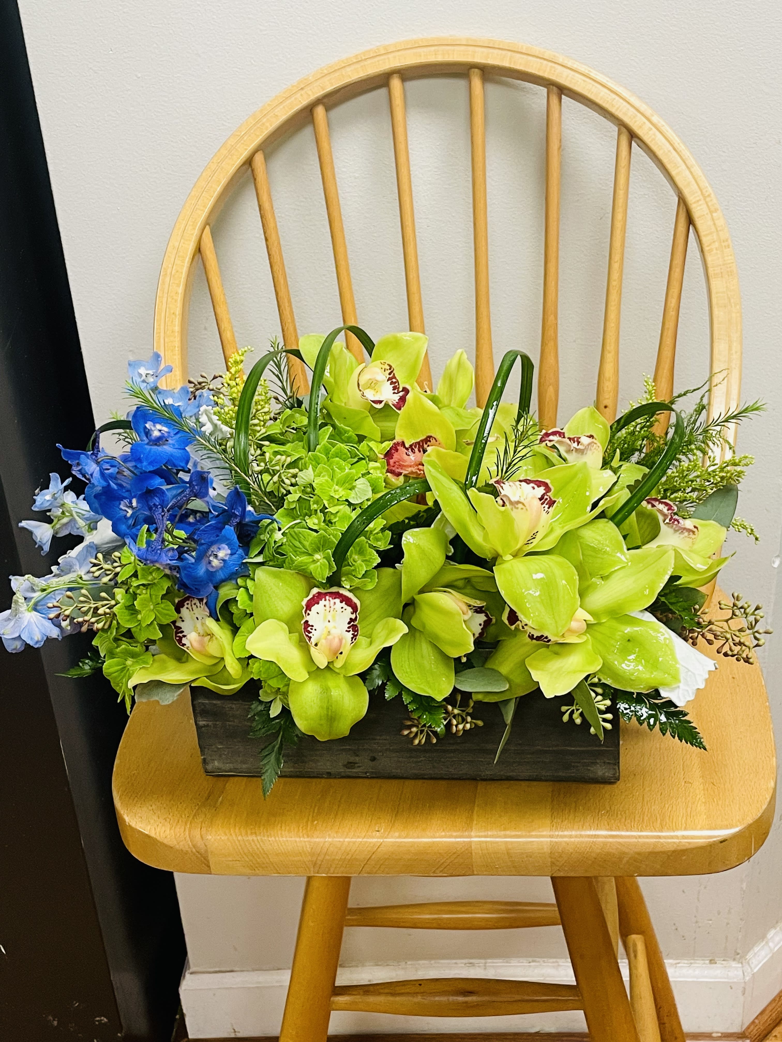 Blue Orchid Fusion - Welcome to Floral Harmony, where we celebrate the enchanting union of nature's finest hues - Dulfinium Blue and Cymbidium Orchid Green. Our arrangements effortlessly blend the soothing tranquility of blue with the vibrant energy of green, creating a visual symphony that delights the senses. Each design is meticulously crafted to evoke a sense of serenity and elegance, making it perfect for any occasion, from weddings to corporate events. Discover the captivating allure of Dulfinium Blue and Cymbidium Orchid Green with Floral Harmony, where artistry and nature converge in harmonious splendor.