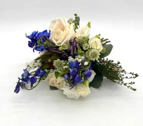 Blue and White Nosegay - Gorgeous look with a variety of fresh blue and white florals. When ordering please specify your choice of satin ribbon color under special instructions or it will be wrapped in a corresponding color. Designers may need to implement substitutions, however will follow the general arrangement style and color theme. Standard price point is pictured.