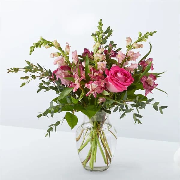 Evermore Bouquet - Fairytale–pink roses, hot pink alstroemeria, and pink snapdragons make an enchanting bouquet fit for any princess.  Please Note: The bouquet pictured reflects our original design for this product. While we always try to follow the color palette, we may replace stems to deliver the freshest bouquet possible, and we may sometimes need to use a different vase.  Details Premium bouquet is approximately 22&quot; H x 22&quot; W  Bloom Details Alstroemeria Eucalyptus Rose