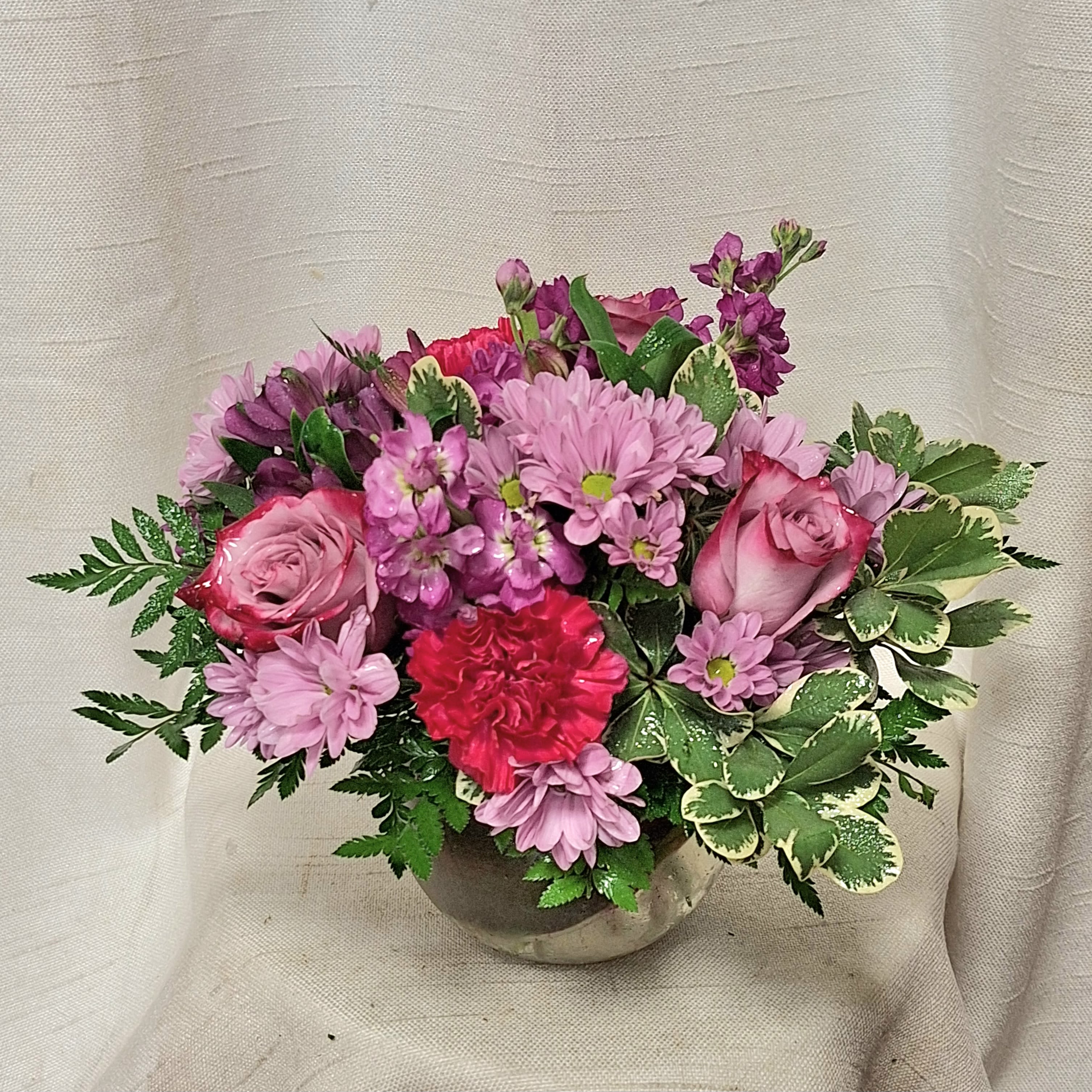 Violet (BR) - This ethereal floral arrangement mesmerizes with a serene blend of purples, featuring the elegant presence of purple alstroemeria and stock, complemented by the delicate beauty of lavender spider mums and mini carnations.