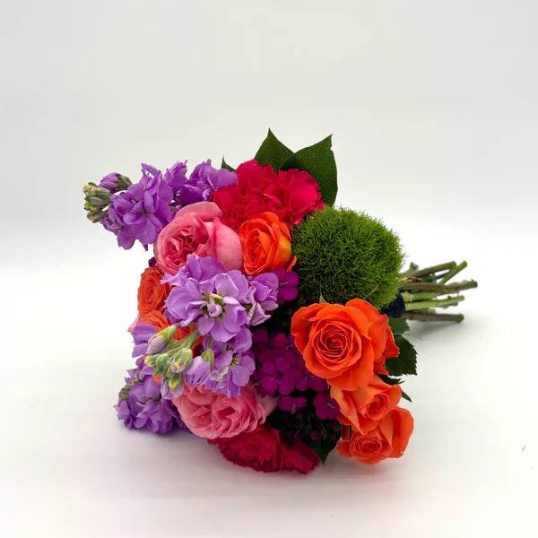 Fuchsia Nosegay - Gorgeous look with a variety of vibrant colors including purple, pink, and orange. When ordering please specify your choice of satin ribbon color under special instructions or it will be wrapped in a corresponding color. Designers may need to implement substitutions, however will follow the general arrangement style and color theme. Standard price point is pictured.