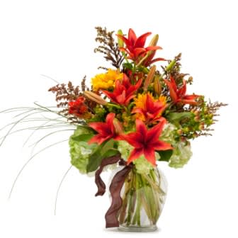 âFields of Autumn TMF13-241 âFields of Autumn TMF13-241 - Our Premium Design features a selection of premium blooms in bright fall colors designed in a clear vase. This size fits well on a dining room table â or a coffee table. Approximately 9" (W) x 12 (H)
