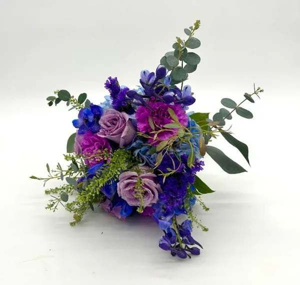 Moonlight Nosegay - Vibrant look with a variety of fresh blue and violet florals. When ordering please specify your choice of satin ribbon color under special instructions or it will be wrapped in a corresponding color. Designers may need to implement substitutions, however will follow the general arrangement style and color theme. Standard price point is pictured.