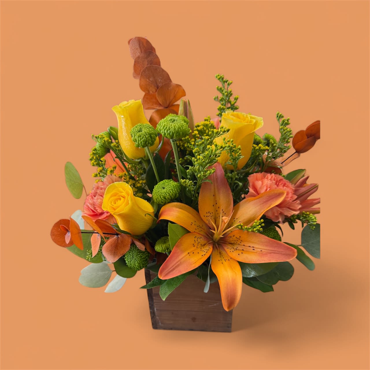 Fall Cheer - Wood Box full of colorful fall tones. Includes roses, lilies carnations, button mums and fall foliage.