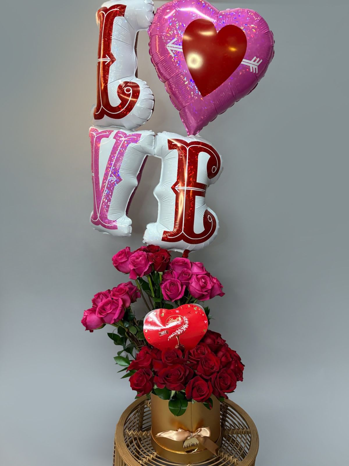 Eternal Love - Make a grand romantic gesture with our Eternal Love Arrangement, featuring 36 exquisite red and pink roses symbolizing passion and admiration. Paired with a Lindor Valentine's Milk Chocolate Truffles Heart, this arrangement indulges the senses with rich, creamy sweetness. To complete the celebration, a dazzling 46&quot; Holographic LOVE Heart &amp; Arrows Foil Balloon adds a touch of magic and joy. Perfect for sweeping your special someone off their feet, this breathtaking gift captures the essence of love in full bloom.