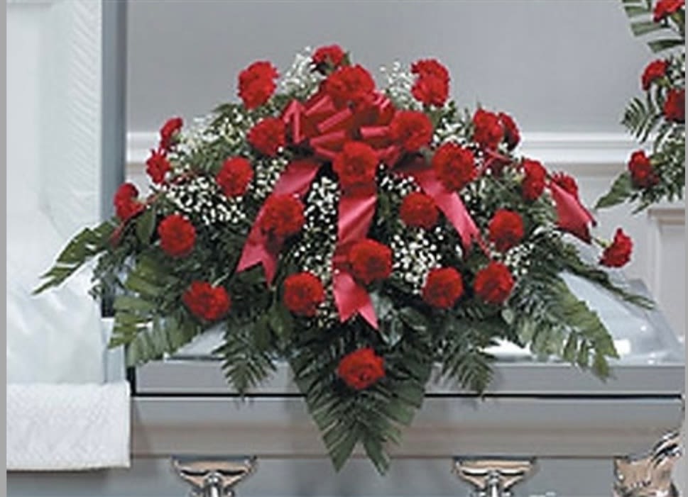 Red carnation casket Spray Red carnation casket Spray - This classic spray features all red carnations.