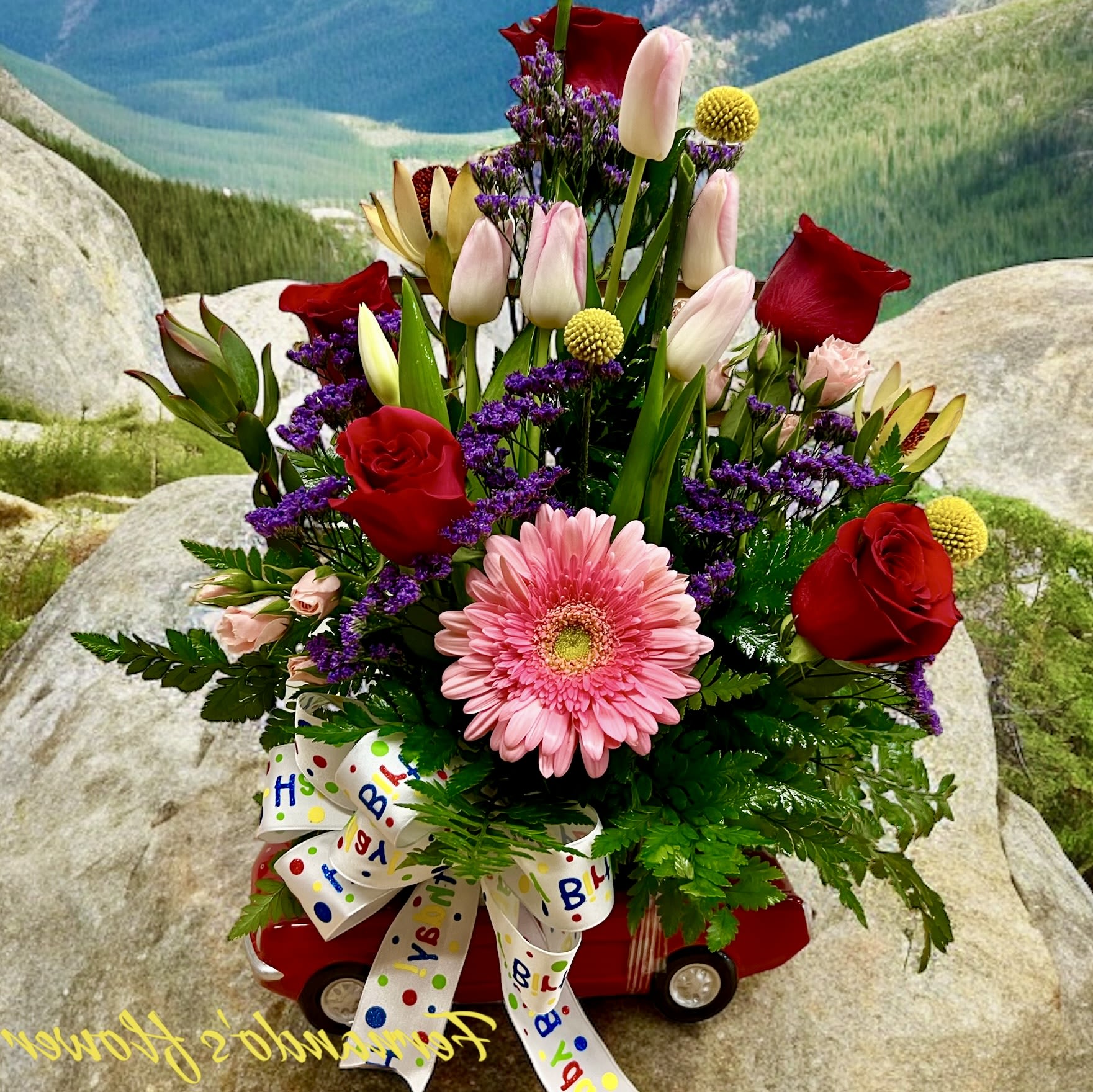 Red Mustang - Mustang Birthday Floral Arrangement   A vibrant mix of fresh flowers arranged in a stylish red Mustang container, perfect for car enthusiasts! Featuring roses, tulips, gerbera daisies, and festive accents, this unique design is a fun and thoughtful way to celebrate any special occasion.   Includes a birthday ribbon for a festive touch!   Order now for delivery!