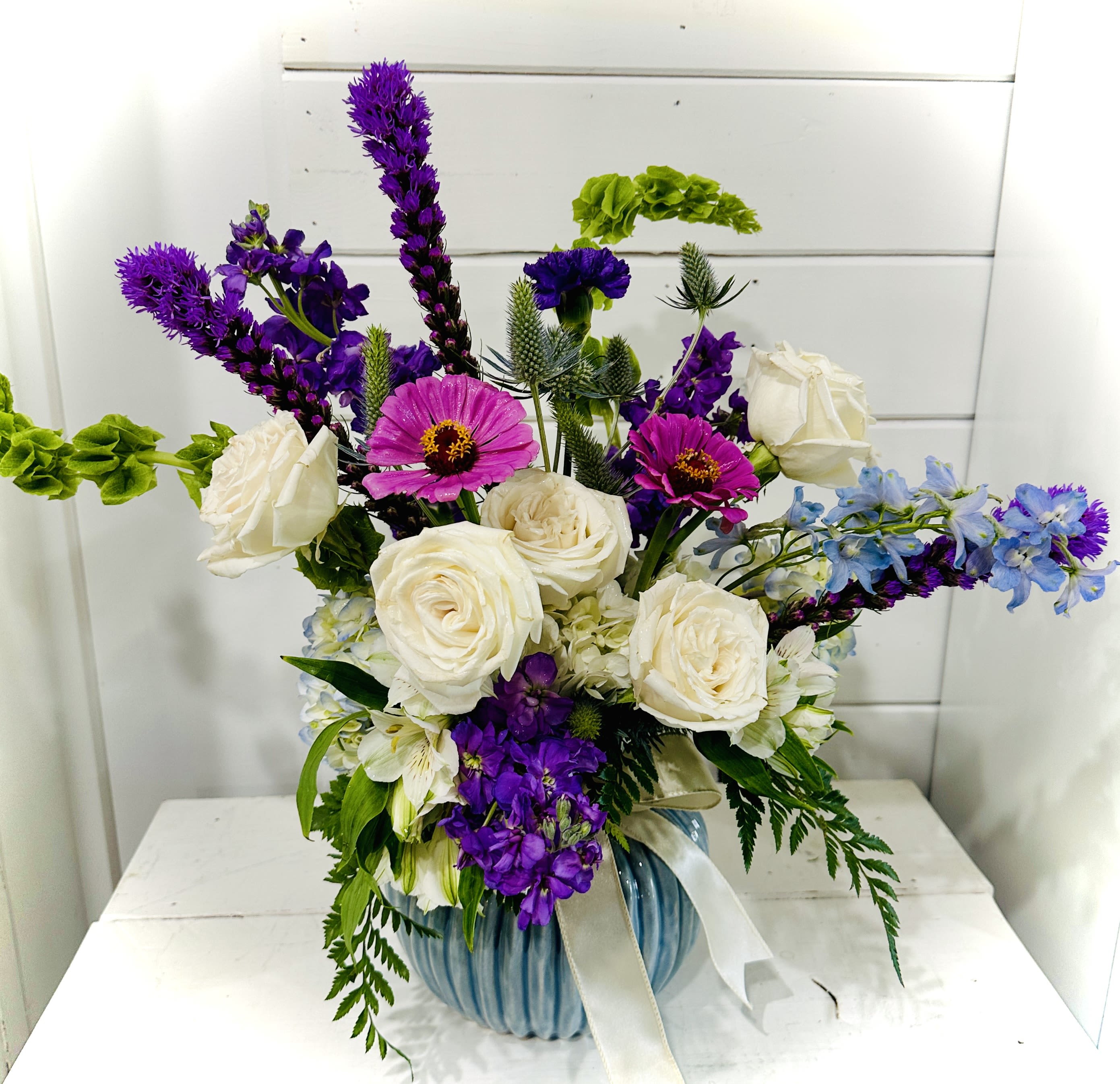 Purple Perfection - This designer bouquet is full of color and elegance!  A special vase filled with stunning blooms will take the breath of that special someone in your life!