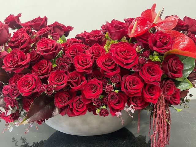 Love Affair Love Affair - A sea of deep red roses with lush red spray roses and striking anthurium, creating a grand, luxurious display of love. “These arrangements are extra grand and filled with lots of beautiful flowers. Since they take more time to create, we kindly ask that you place your order in advance or allow us a few extra hours before delivery.” Some florals are seasonal, if particular flower will not be available due to season, we will substitute for similar flower, composition, color pallet and value of the arrangements as closely as possible. All effort to create a floral arrangement as close to the photo shown, the actual arrangement may vary slightly in its appearance from the photo shown. If you have any questions about your order, we welcome you to call us in or email