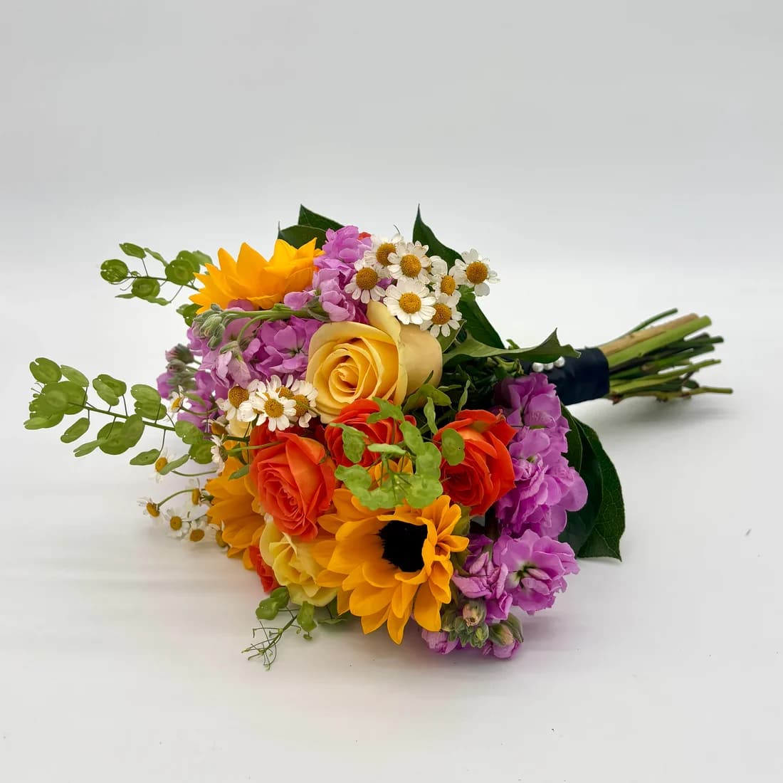 Summer Lovin' Nosegay - Fabulous look with a variety of bright and colorful florals. When ordering please specify your choice of satin ribbon color under special instructions or it will be wrapped in a neutral color. Designers may need to implement substitutions, however will follow the general arrangement style and color theme. Standard price point is pictured.