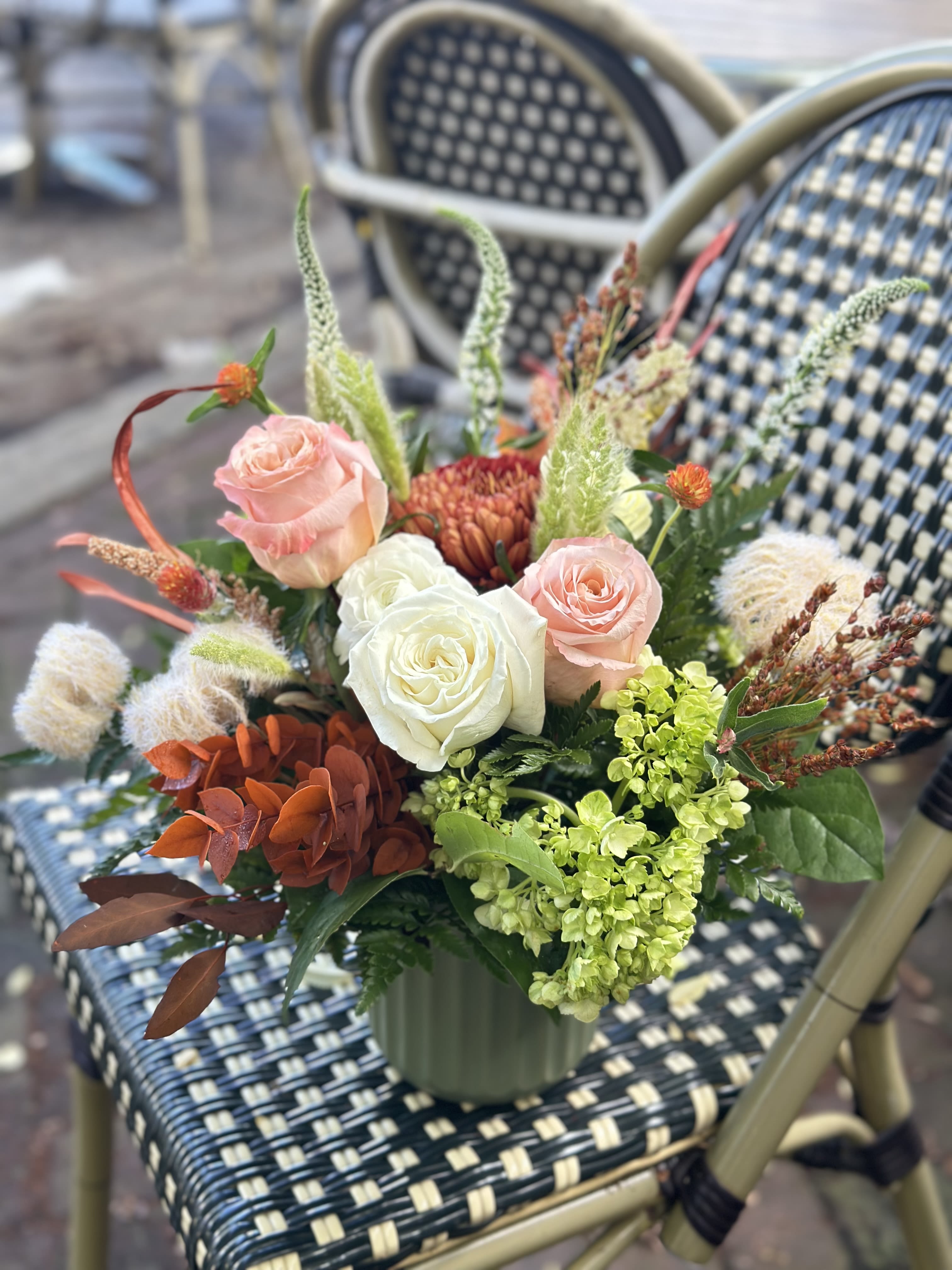 Sligo Creek - Inspired by the quiet elegance of autumn, this arrangement blends soft neutral tones with seasonal textures for a look that's both refined and comforting. Earthy blooms and muted foliage capture the essence of fall's natural beauty, making it the perfect centerpiece for cozy gatherings or a thoughtful gift that carries the warmth of the season.