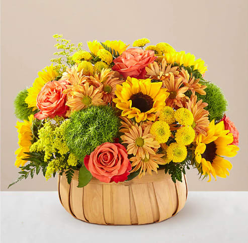 Harvest Sunflower Basket - Rustic, natural beauty and vibrant shades fill this arrangement. Our Harvest Sunflower Basket is the perfect mix of bold sunflowers, roses and dianthus in a natural woven basket. Woven basket may vary in style.