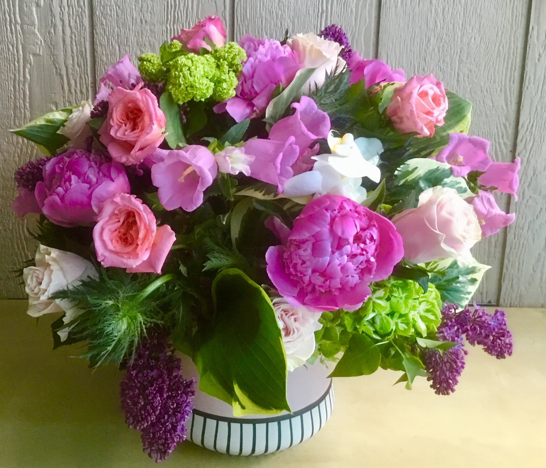 Funny Girl - In a beautiful pink ceramic vase combination off pink roses, green hydrangeas, peonies, tulips,  Campanula is arranged by Jane's Roses of San Francisco