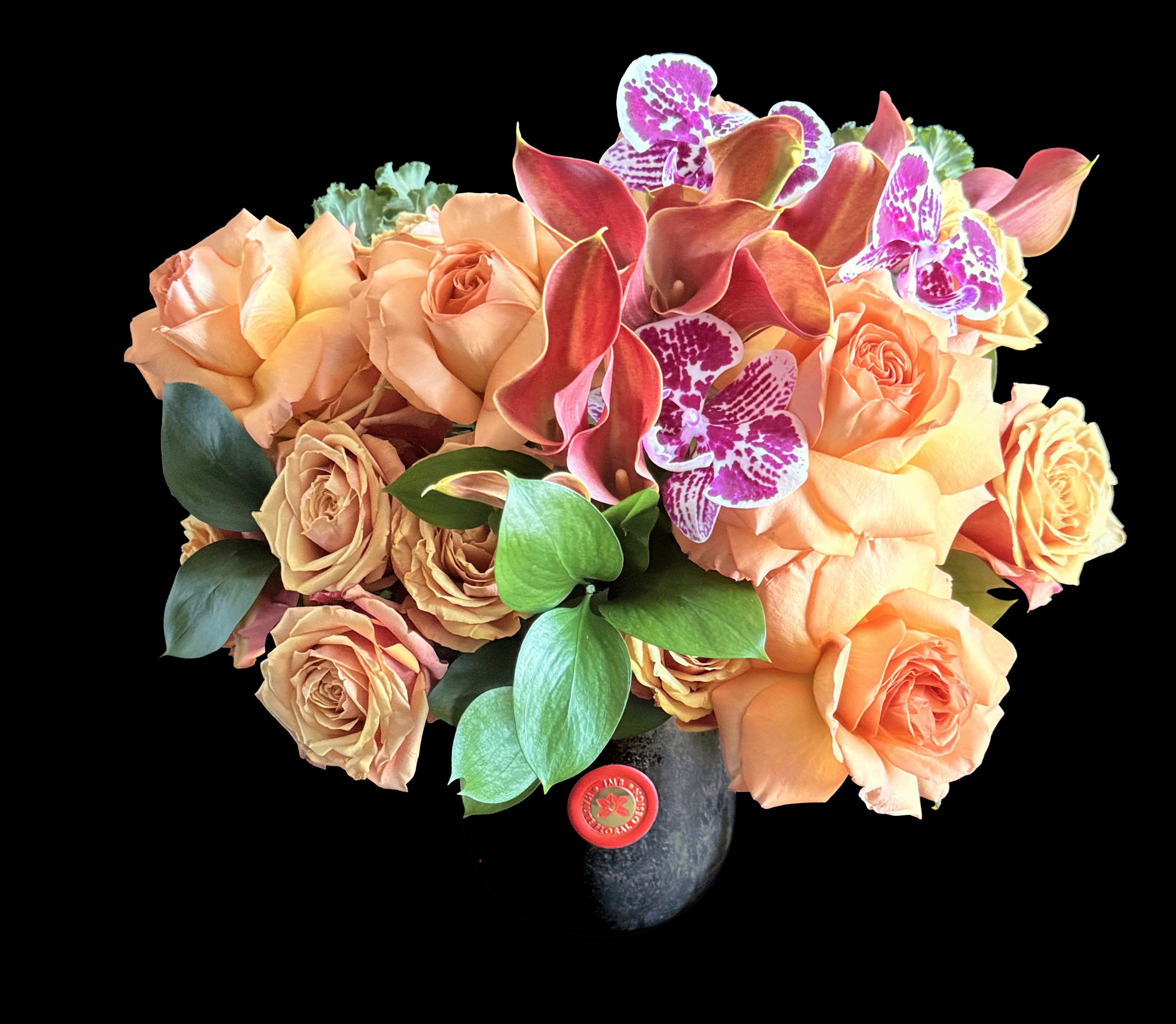 Pumpkin Berry Pumpkin Berry - Floral in orange and purple toned blooms in black marble container.