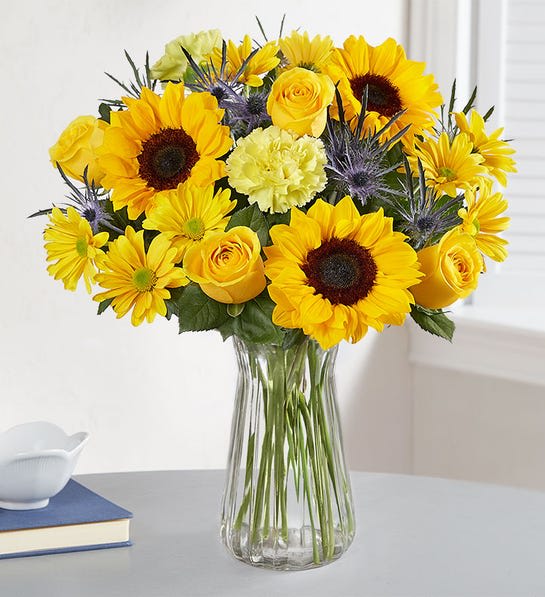 Radiant Sunshine - Like a ray of sunshine, our radiant bouquet dials up the happy all summer long. A mix of yellow blooms is gathered together to deliver your best wishes for a season of celebrating, connecting and growing closer.