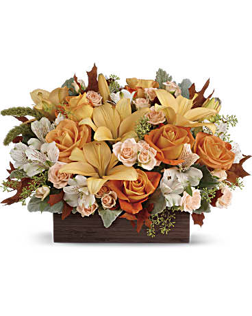 Fall Chic Bouquet Fall Chic Bouquet - Simply chic and overflowing with fall blooms! This gorgeous arrangement is sure to impress with its glorious shades of autumn - combining orange roses, peach lilies and seasonal brown leaves. Hand-delivered in a dark-toned bamboo rectangle.