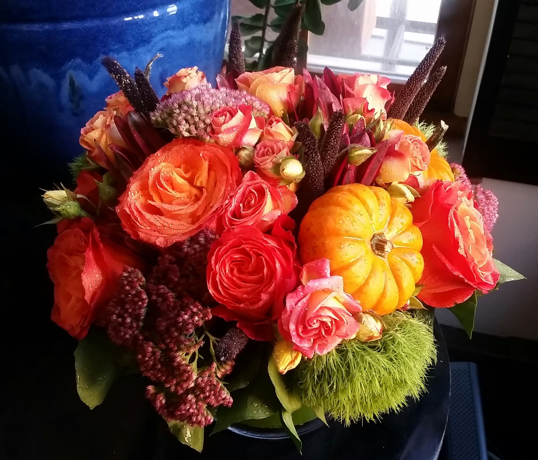 Floral Harvest - A beautiful arrangement of seasonal fall flowers adorned with fresh picked pumpkins