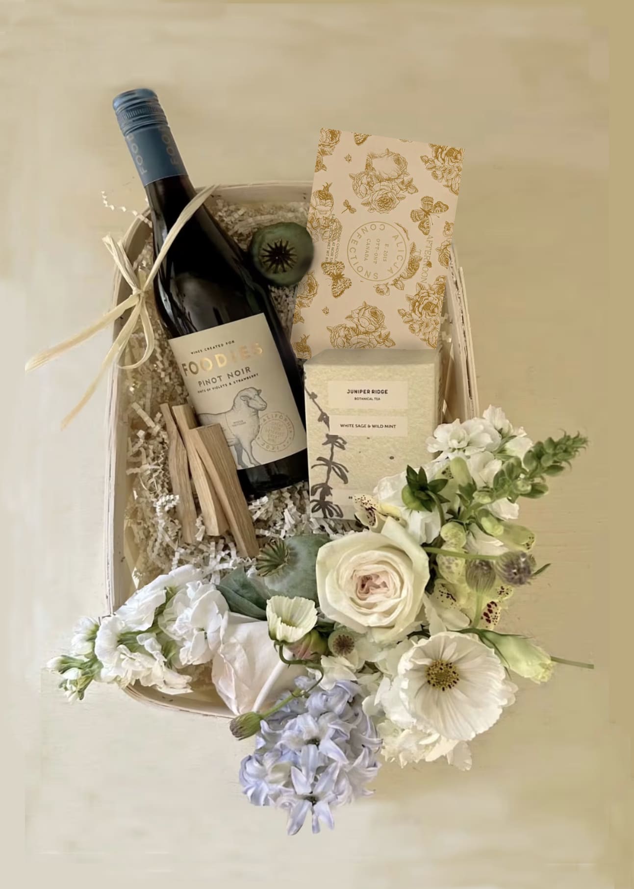 Miles Mint Gift Basket - White and pale greens and blues in this lovely and beautiful gift basket with Pinot Noir wine, Wild mint herbal tea, Madhu Vegan dark chocolate bar &quot;Afternoon Tea&quot;, Palo Santo sticks and a cute mini vase of Blomst signature flowers all in white colors. Available for daily hand delivery in LA by our own delivery staff. Looking to ship out of state? Go to our siter site www.blomstlosangeles.com