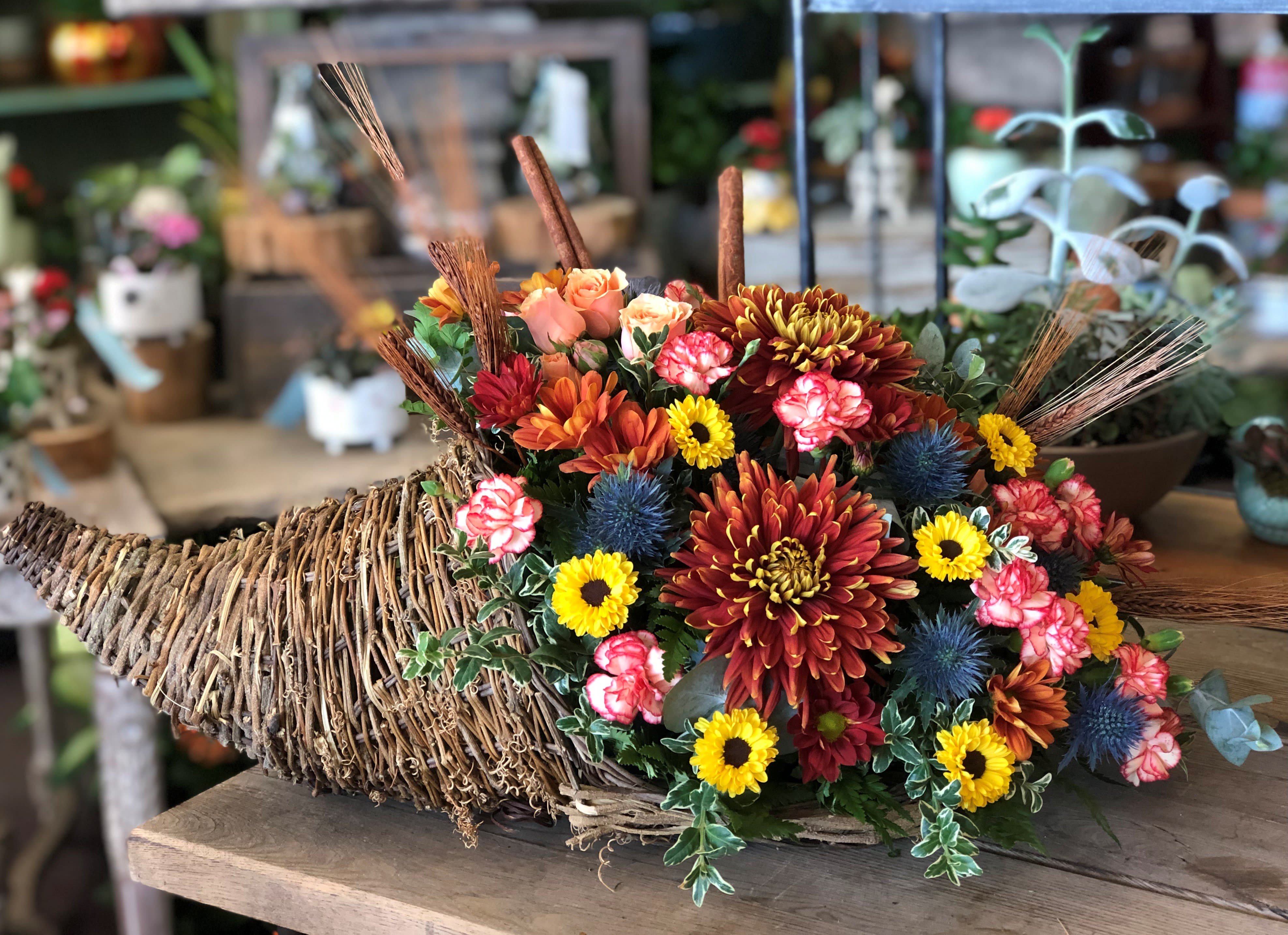 Autumn Cornucopia - With its assortment of fall flowers this beautiful cornucopia will add great taste to any table setting. This is our larger version which is approximately 26 inches long and 14 inches wide.