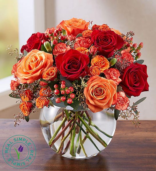 Burst of autumn  - A warm medley of color transforms our autumn arrangement into an elegant classic. Designed exclusively through our partnership with Real Simple®, it’s filled with rich red and orange blooms, beautifully displayed inside a modern bubble bowl vase. With an undeniable charm, it’s an impressive gift for sharing, or for showcasing in your own home.