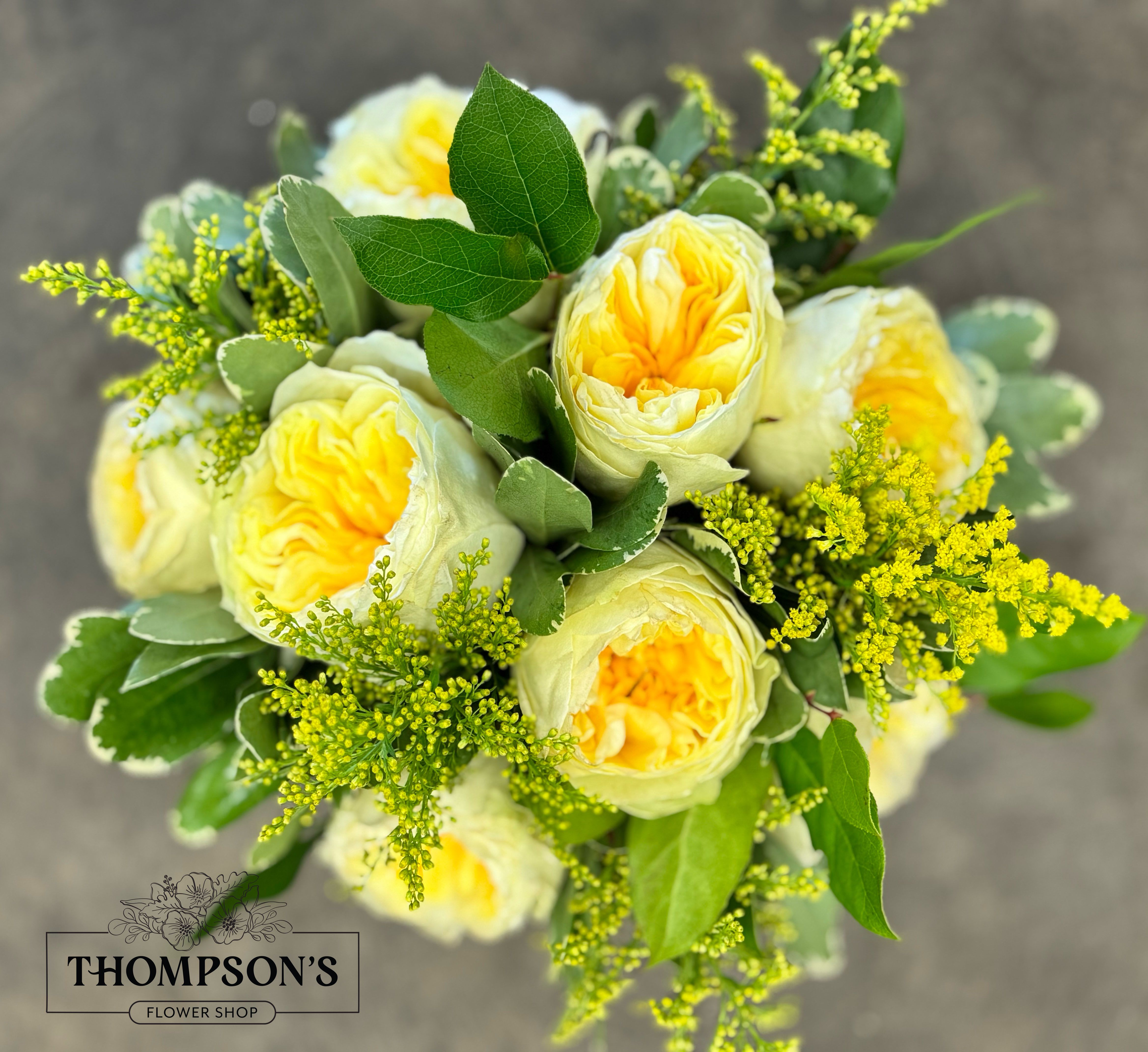 Sunburst - Brighten any day with this vibrant bouquet of golden-yellow garden roses accented by lush greenery and solidago. Fresh, sunny, and full of warmth, Sunburst is perfect for celebrating birthdays, sending cheer, or simply making someone smile. Hand-delivered from Thompson’s Flower Shop in Goodyear, AZ.