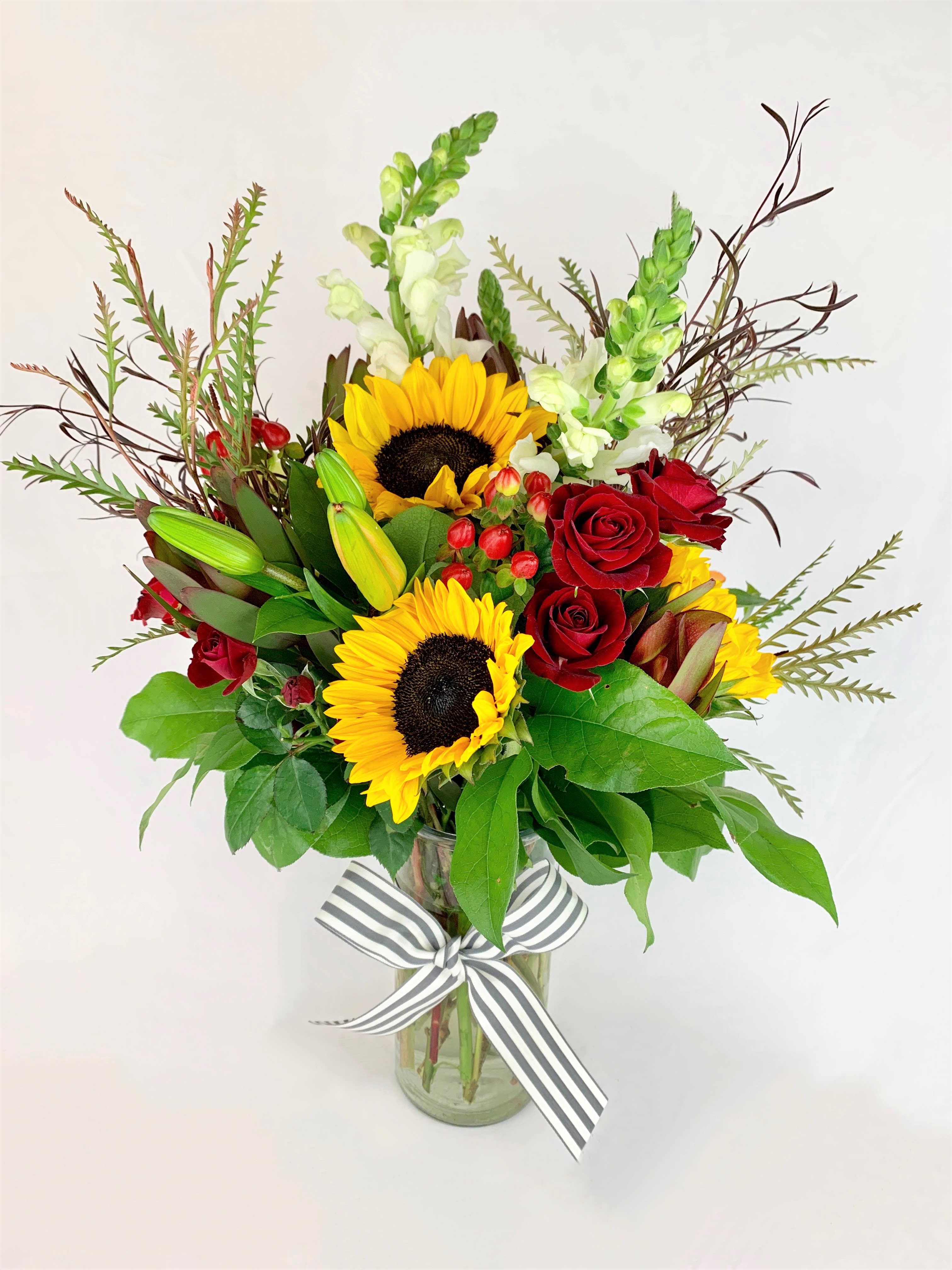 Hello Fall! - Welcome crisp nights and sun warmed days! Includes sunflowers, hypericum berries, spray roses, snapdragons, lilies, and safari sunset.