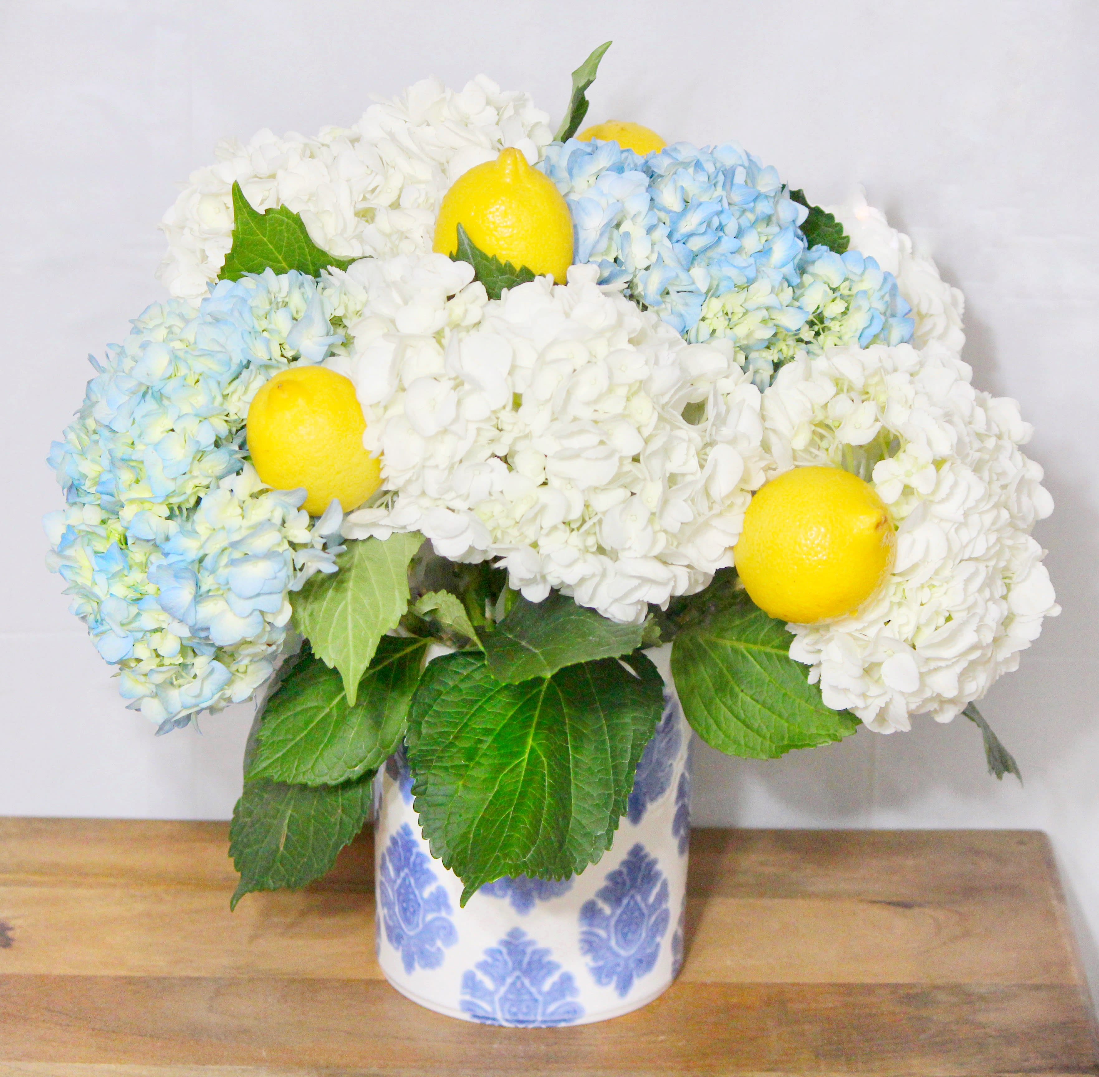 French sunshine - Hydrangeas and lemons in a French country crock  vase.
