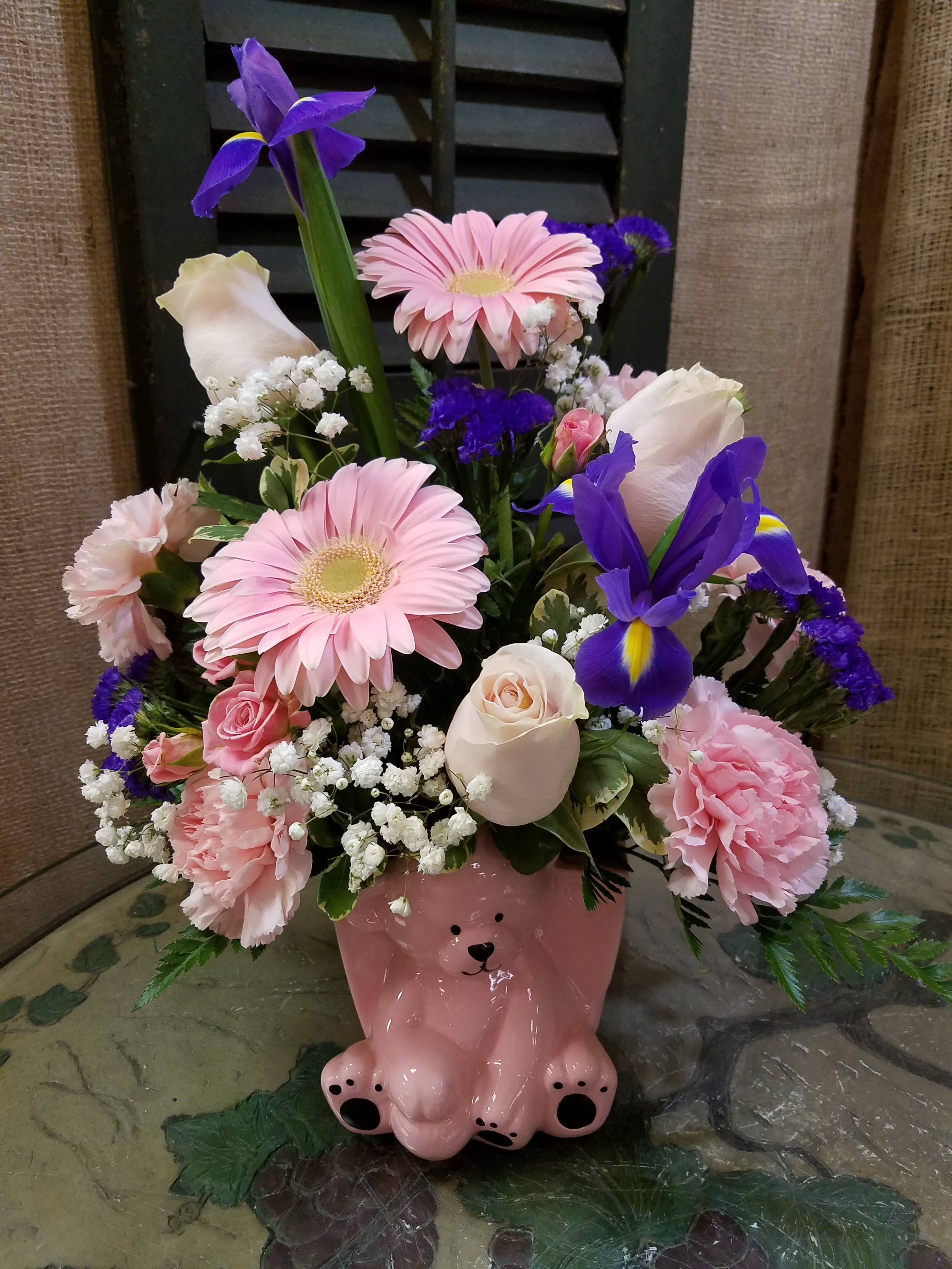 Floral Baby Gift - Floral Baby Gift – Fresh Flower Arrangement  Welcome the newest bundle of joy with our Floral Baby Gift, a fresh flower arrangement designed to celebrate life’s sweetest moments. Featured in an adorable ceramic baby-themed container, this arrangement makes the perfect gift for new parents or a baby shower centerpiece.  Shown here in charming shades of pinks and purples, this design is full of vibrant, long-lasting blooms. We also offer additional color options to suit your preference. Ordering for a baby boy? Simply specify in the special instructions and we’ll create a beautiful arrangement in coordinating colors.  Each Floral Baby Gift is handcrafted by our designers at Haehn Florist and Greenhouses with the freshest flowers available, making every arrangement unique and memorable.   Visit Us: Haehn Florist &amp; Greenhouses, 410 Hamilton Rd., Wapakoneta, OH 45895  Call Us: 419-738-8485  Order Online Anytime: www.haehnflorist.com  Celebrate new beginnings with flowers that say it all. Order the Floral Baby Gift today!