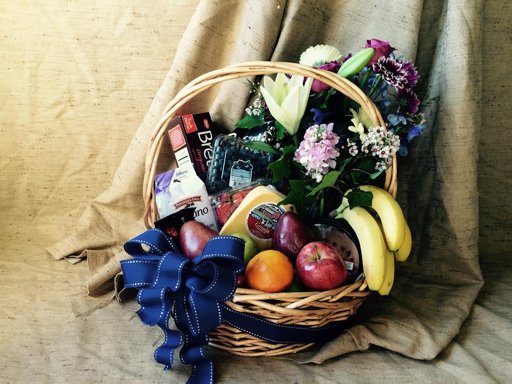 Fruit, gourmet, and flower basket Fruit, gourmet, and flower basket - A feast for the body and the soul! Delicious assortment of gourmet items such as cheese, crackers, nuts, spreads, chocolates, fruit; and a lovely arrangement of the seasons finest flowers.