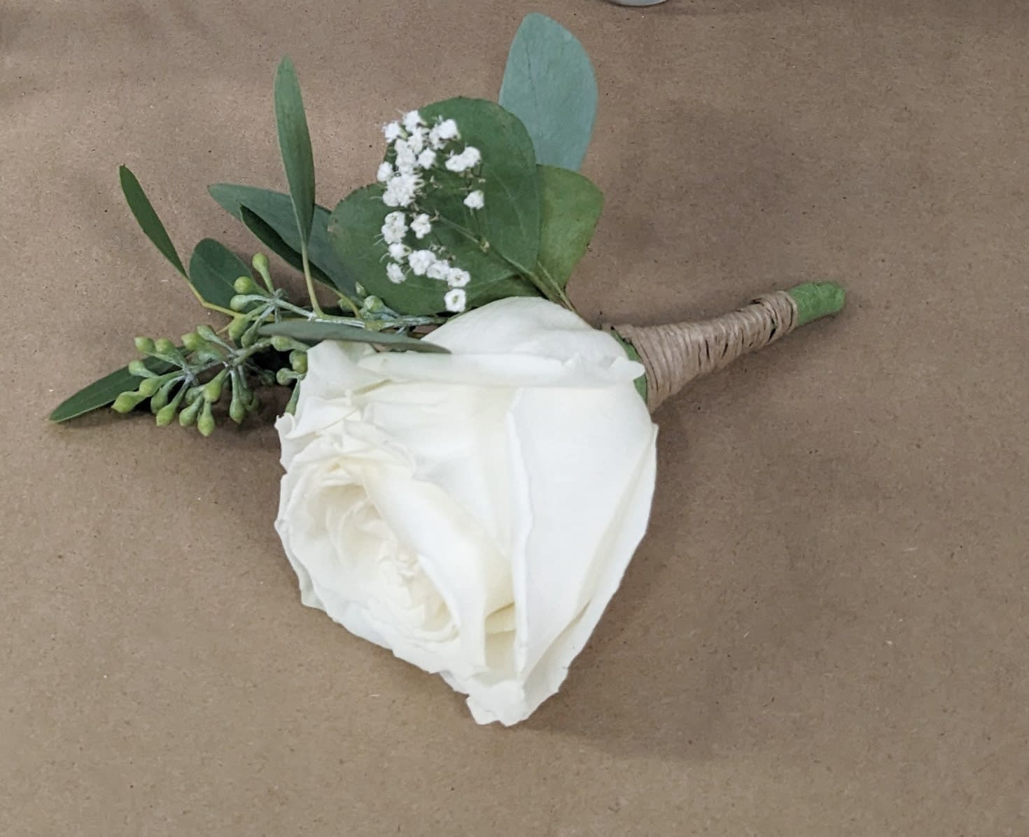 White Rose Boutonnière - A classic white boutonnière that compliments any suit. A perfect addition for any prom, formal, or wedding event. 