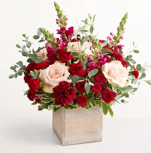 Harvest Dreams  Bouquet - This is the bouquet they’ve been dreaming of: rustic yet refined, organic and eye-catching. Pale roses nestle among burgundy blooms and airy greenery artfully arranged in a crescent shape. It arrives in a wooden cube that adds to its pastoral charm.