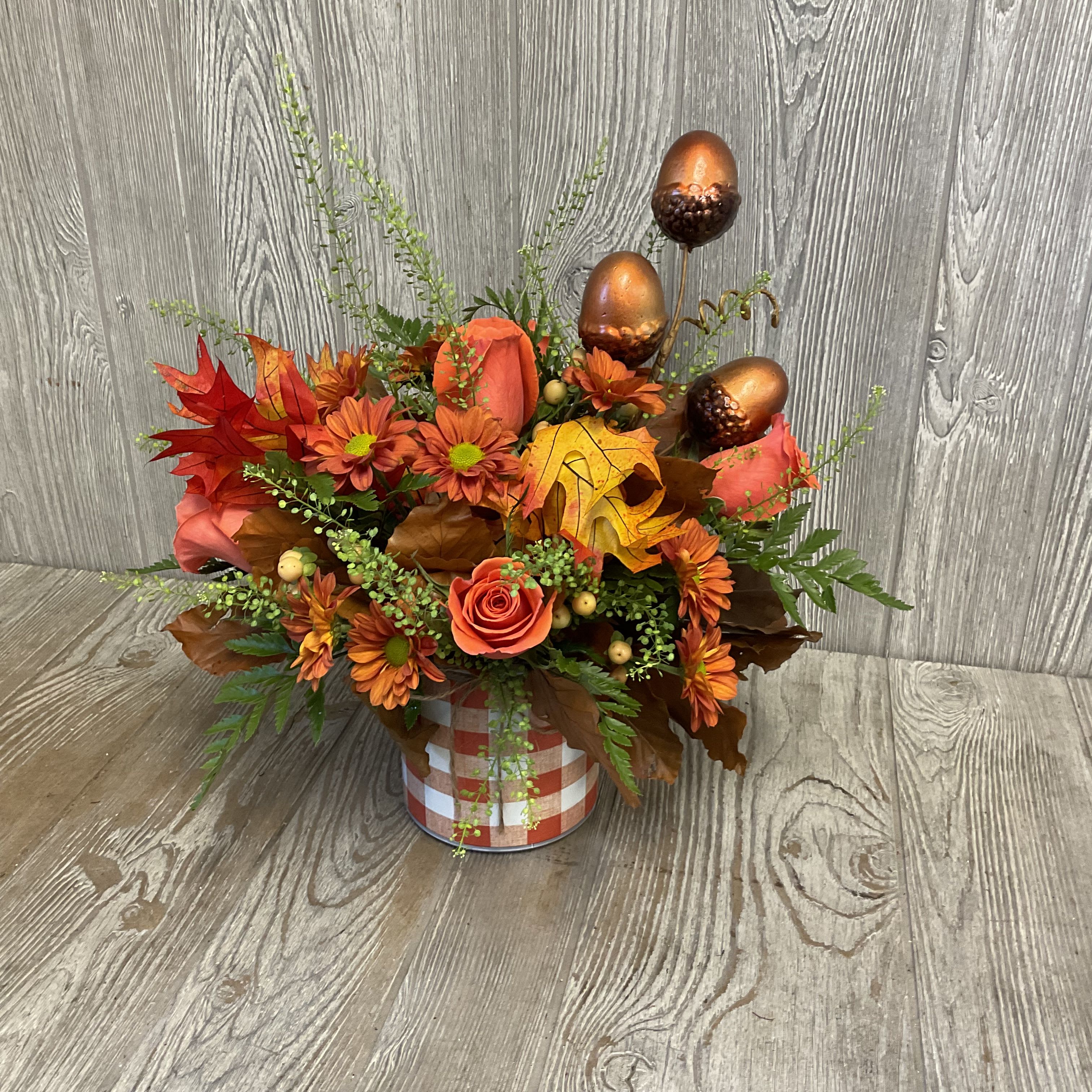 Leaves of Fall - Keepsake cylinder orange gingham container with an assortment of fall colored flowers, leaves and acorns. Great for a centerpiece. 