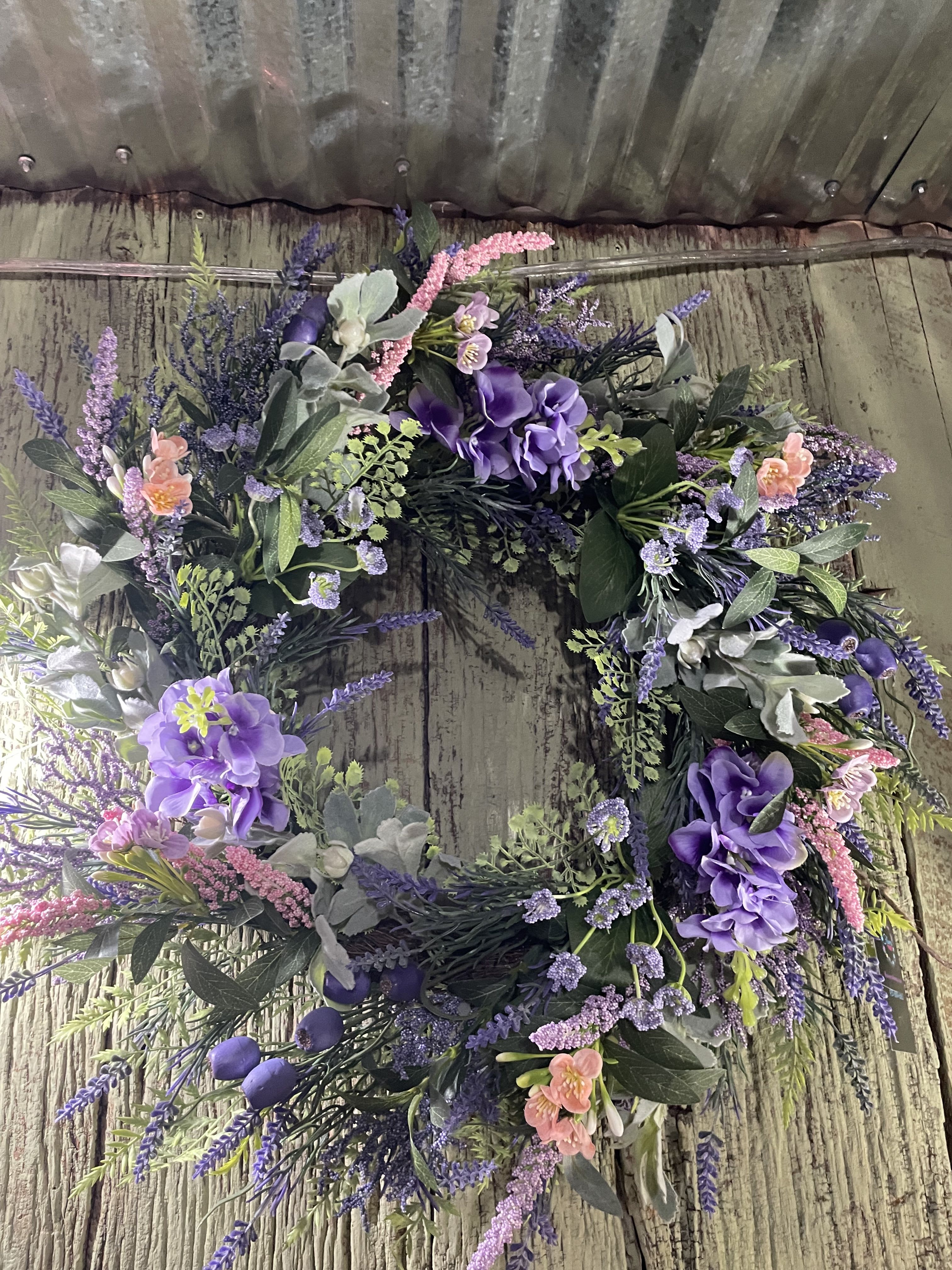 Farmhouse  Wreath -  A lovely broomstick wreath surrounded by creams, lavender, greens, pinks and plaid ribbons - on a stand for services